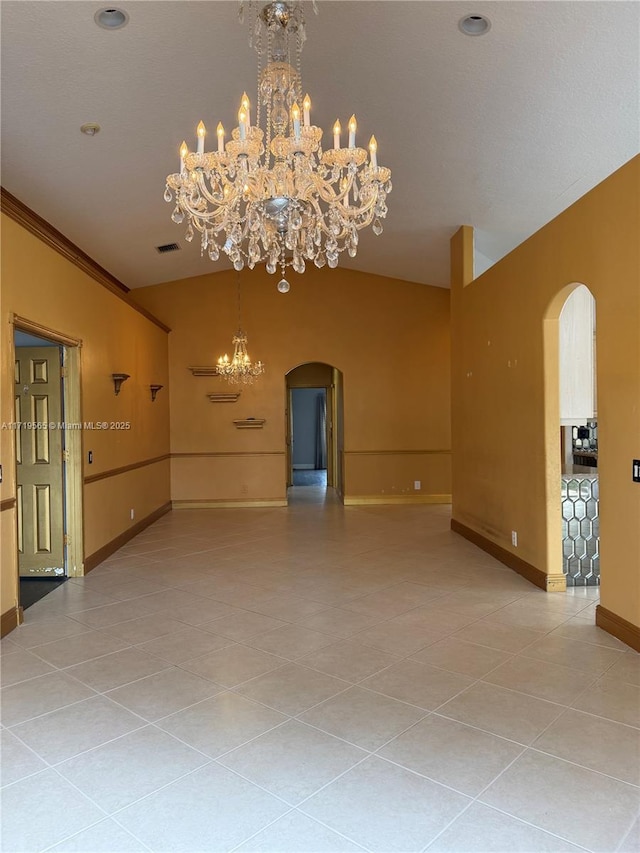 unfurnished room with ornamental molding, an inviting chandelier, and tile patterned floors