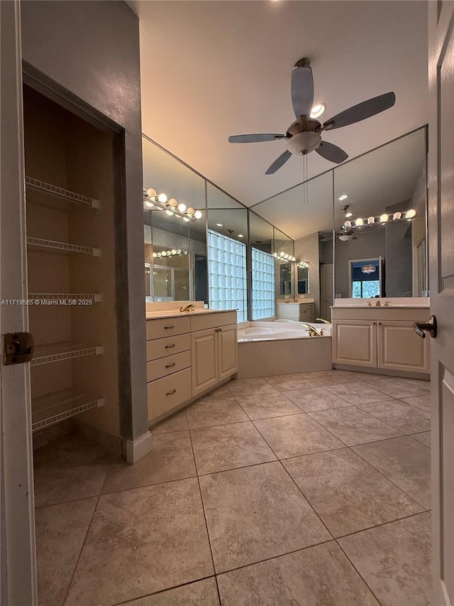 bathroom with ceiling fan, tile patterned flooring, vanity, and a bathing tub