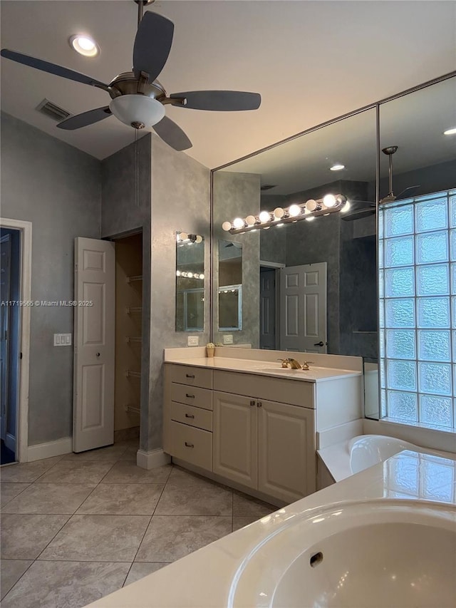 bathroom with vanity, tile patterned flooring, ceiling fan, and a bath