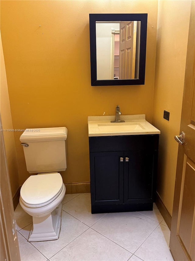 bathroom with toilet, tile patterned flooring, and vanity