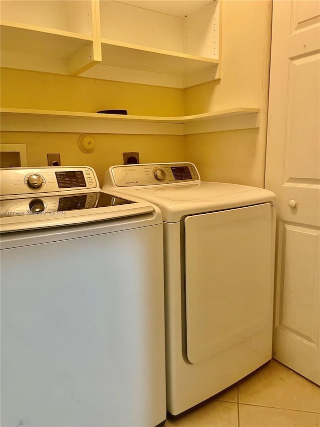 laundry room with light tile patterned flooring and separate washer and dryer