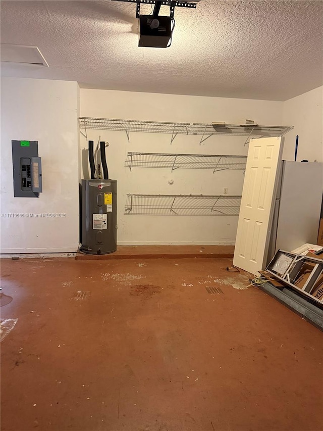 garage featuring electric panel, white refrigerator, water heater, and a garage door opener