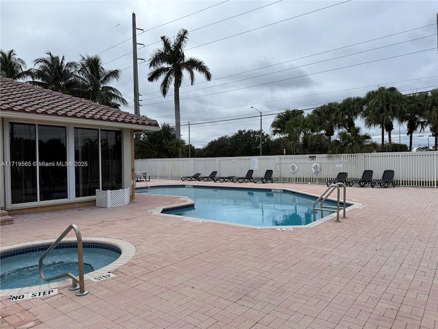 view of swimming pool with a community hot tub and a patio area