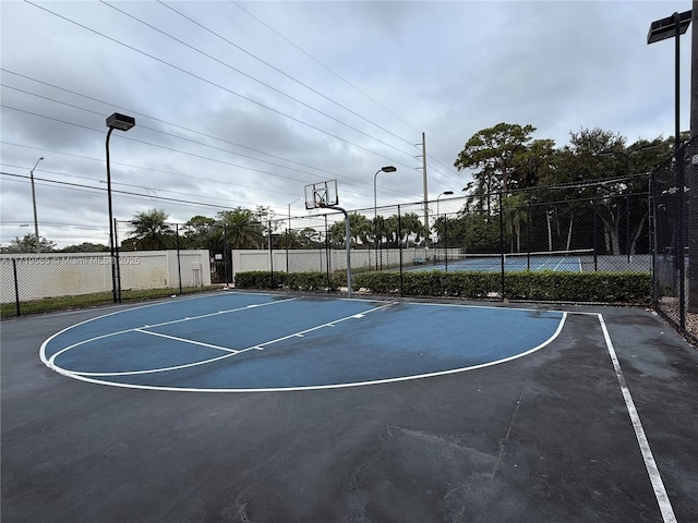 view of basketball court featuring tennis court