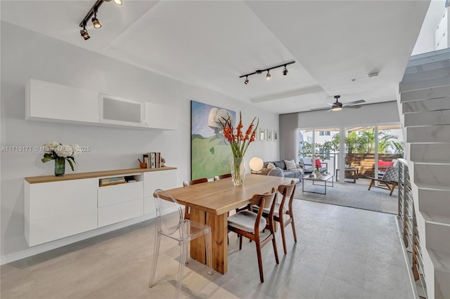 dining room with ceiling fan and rail lighting