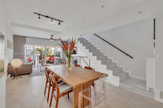 dining area featuring ceiling fan and rail lighting