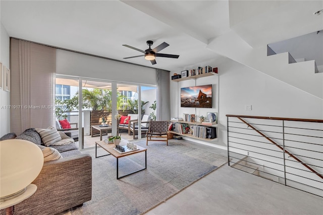 living room with ceiling fan and concrete floors