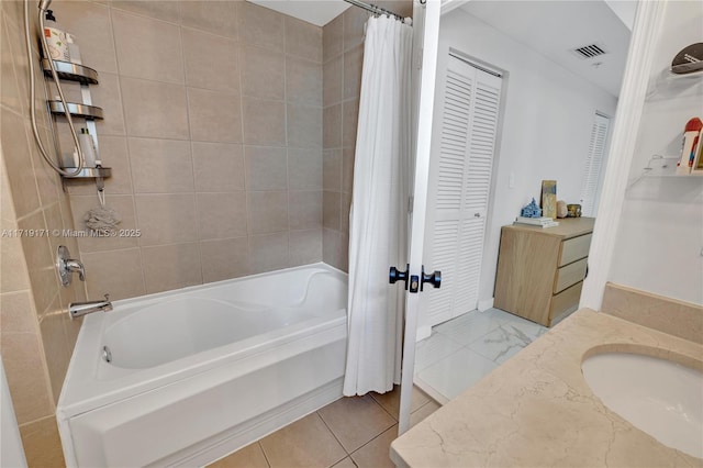 bathroom featuring tile patterned flooring, vanity, and shower / tub combo with curtain