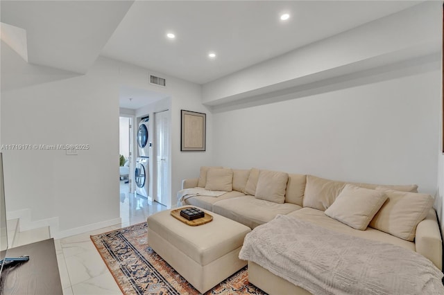 living room with stacked washer / dryer