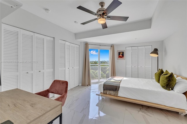 bedroom featuring ceiling fan and two closets