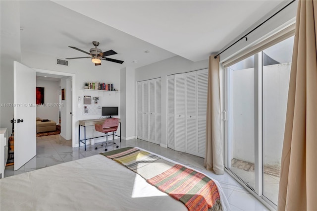 bedroom featuring ceiling fan, access to exterior, and two closets