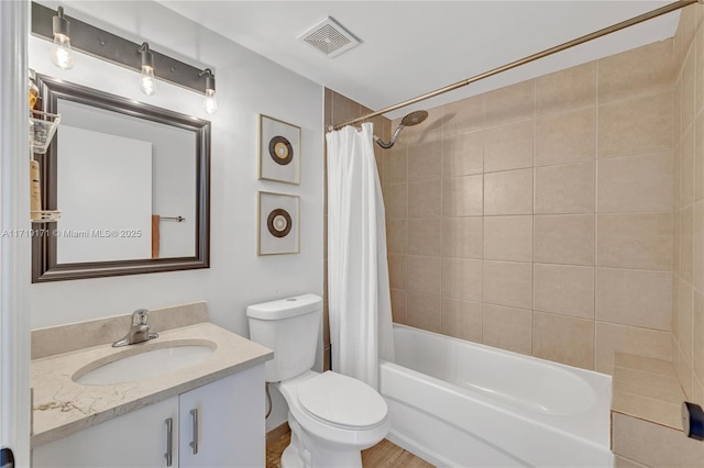 full bathroom featuring shower / bath combo with shower curtain, vanity, and toilet