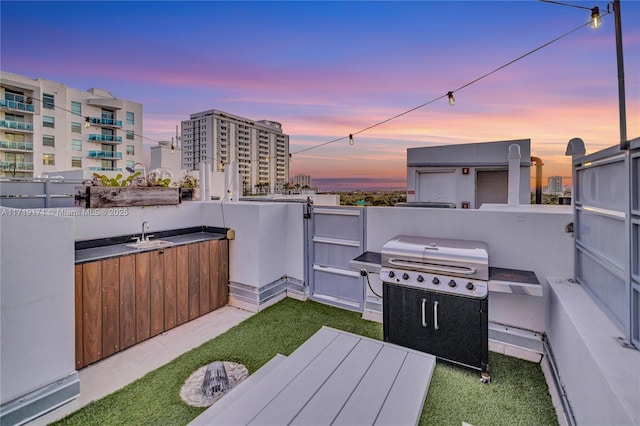 patio terrace at dusk with sink and grilling area