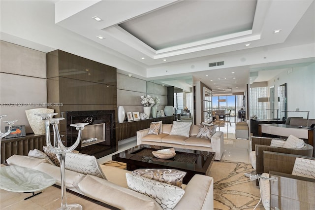 living room featuring a raised ceiling