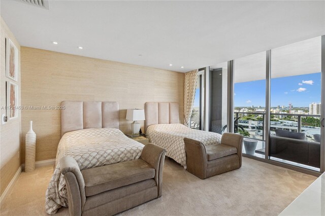 carpeted bedroom featuring expansive windows and access to outside