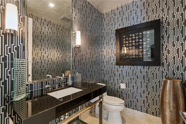 bathroom featuring sink and toilet