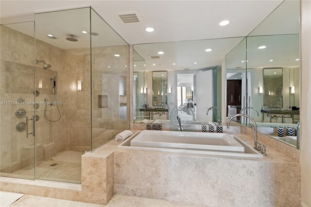 bathroom with tile patterned floors and independent shower and bath