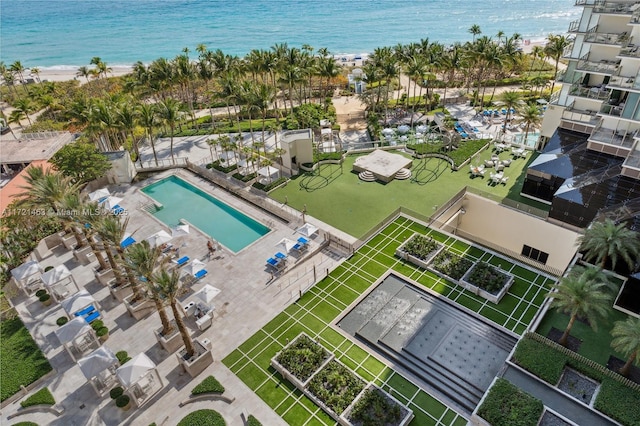 drone / aerial view featuring a water view and a view of the beach