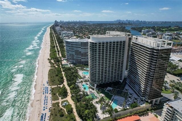 drone / aerial view featuring a water view and a view of the beach