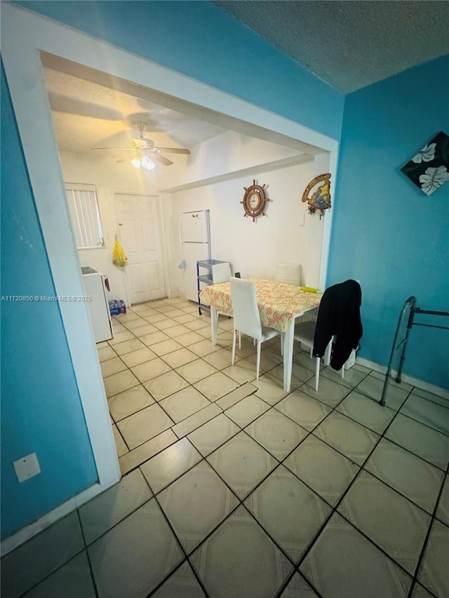 unfurnished dining area featuring a textured ceiling and ceiling fan