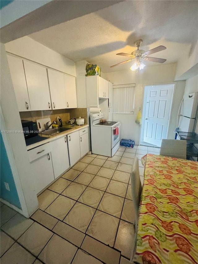 kitchen with white cabinetry, sink, ceiling fan, white electric range, and light tile patterned floors