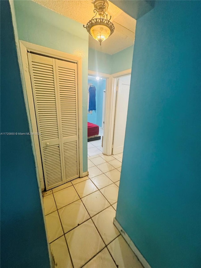 hall featuring light tile patterned flooring