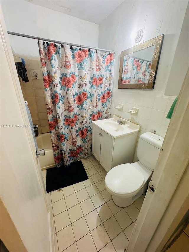 full bathroom with vanity, tile patterned flooring, toilet, tile walls, and shower / tub combo with curtain