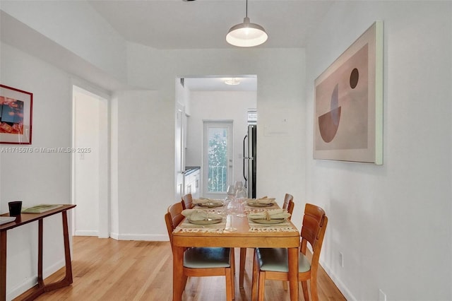 dining space featuring light wood-type flooring