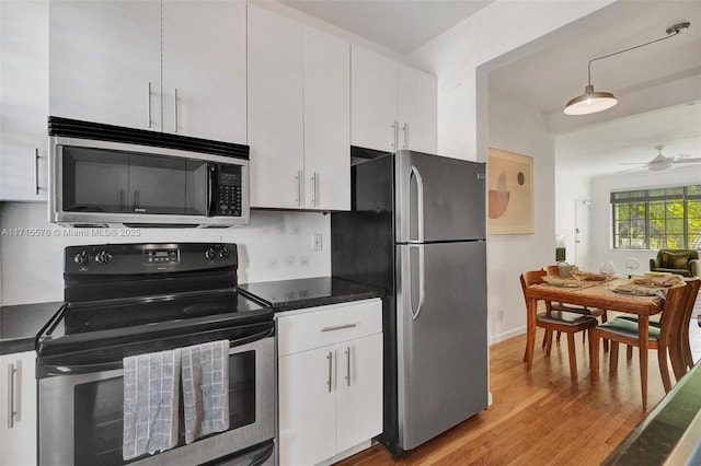 kitchen with white cabinets, ceiling fan, tasteful backsplash, light hardwood / wood-style floors, and stainless steel appliances