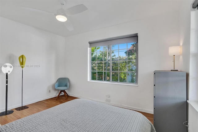 bedroom featuring hardwood / wood-style floors and ceiling fan