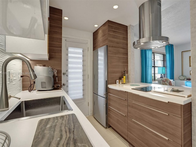 kitchen with stainless steel refrigerator, sink, cooktop, extractor fan, and light tile patterned flooring