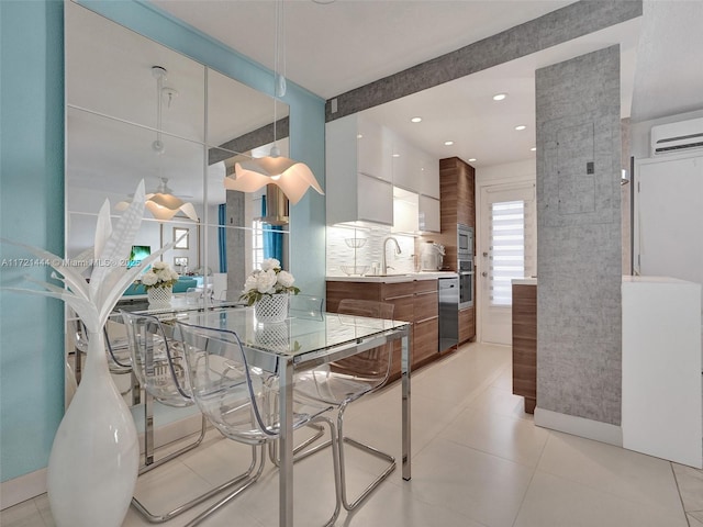 tiled dining room with an AC wall unit and sink