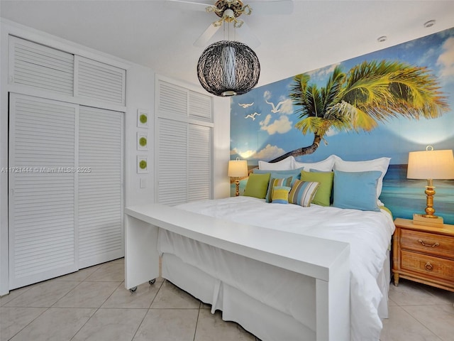 tiled bedroom with a closet and ceiling fan