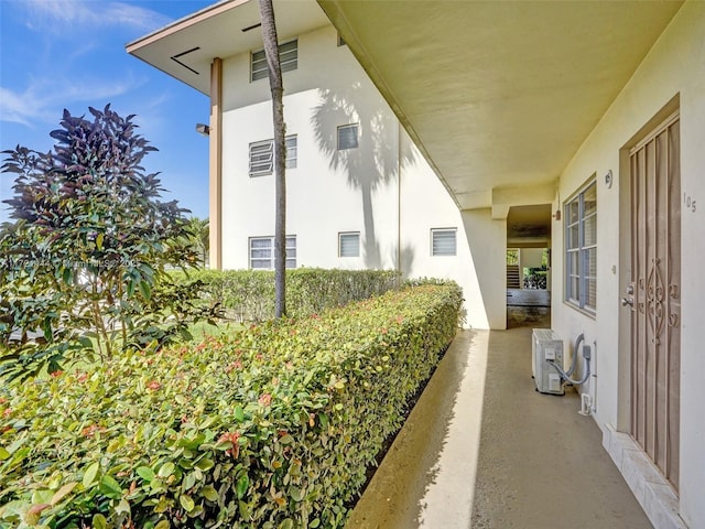 view of side of home with ac unit