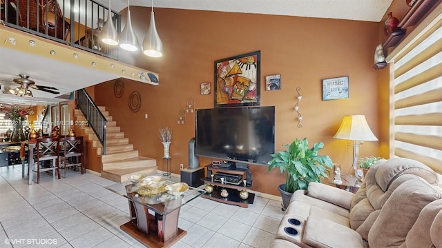 living room featuring tile patterned floors, ceiling fan, and high vaulted ceiling