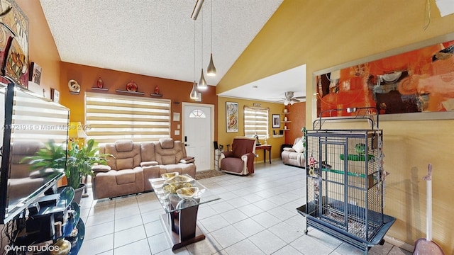 tiled living room with plenty of natural light, ceiling fan, lofted ceiling, and a textured ceiling