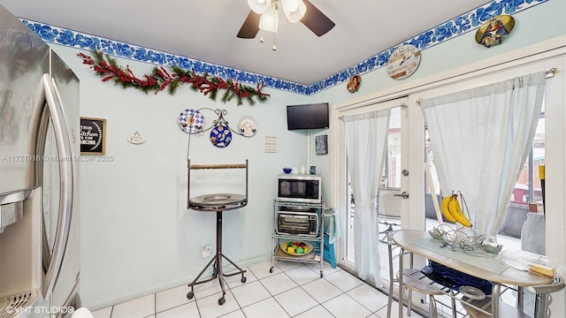 interior space with ceiling fan and light tile patterned flooring