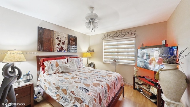 bedroom with ceiling fan and light wood-type flooring