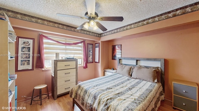 bedroom featuring a textured ceiling, hardwood / wood-style flooring, and ceiling fan