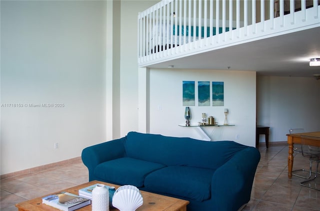 tiled living room with a high ceiling