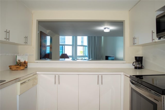 kitchen featuring stainless steel appliances and white cabinetry