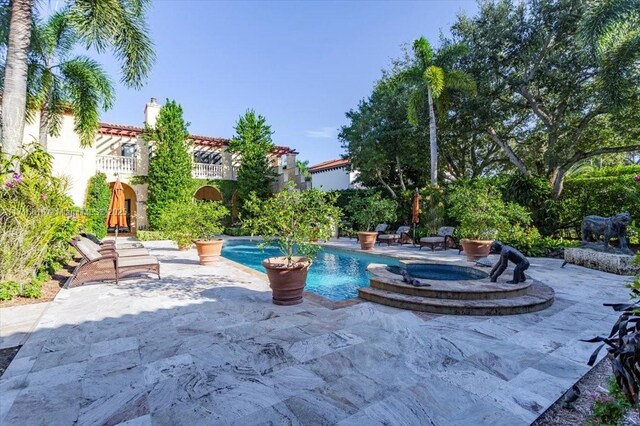 view of swimming pool featuring an in ground hot tub and a patio area