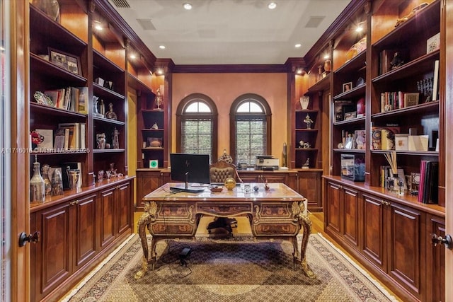 office with crown molding and built in shelves