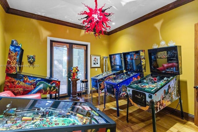 recreation room with hardwood / wood-style flooring and ornamental molding