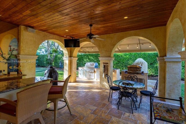 view of patio / terrace featuring grilling area, ceiling fan, and exterior kitchen