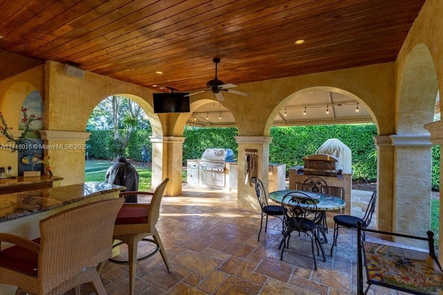 view of patio / terrace with ceiling fan and area for grilling