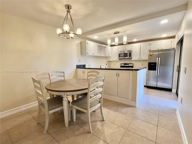 dining area featuring light tile patterned flooring and an inviting chandelier