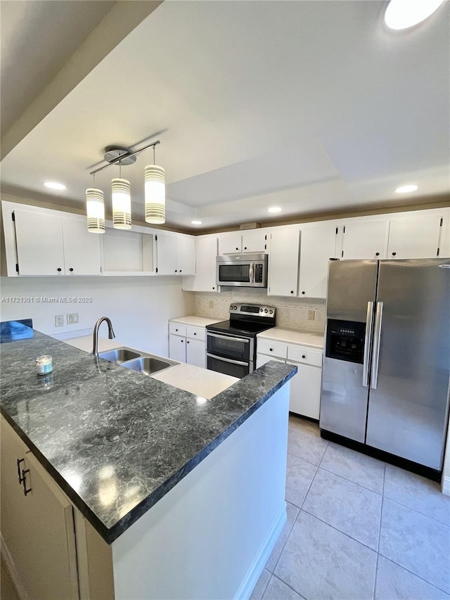 kitchen featuring light tile patterned flooring, sink, white cabinets, and stainless steel appliances