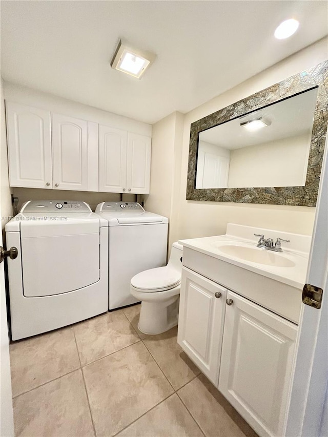 washroom featuring washer and clothes dryer, light tile patterned flooring, and sink