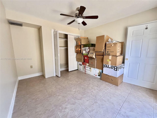 bedroom featuring a closet, ceiling fan, and light tile patterned flooring